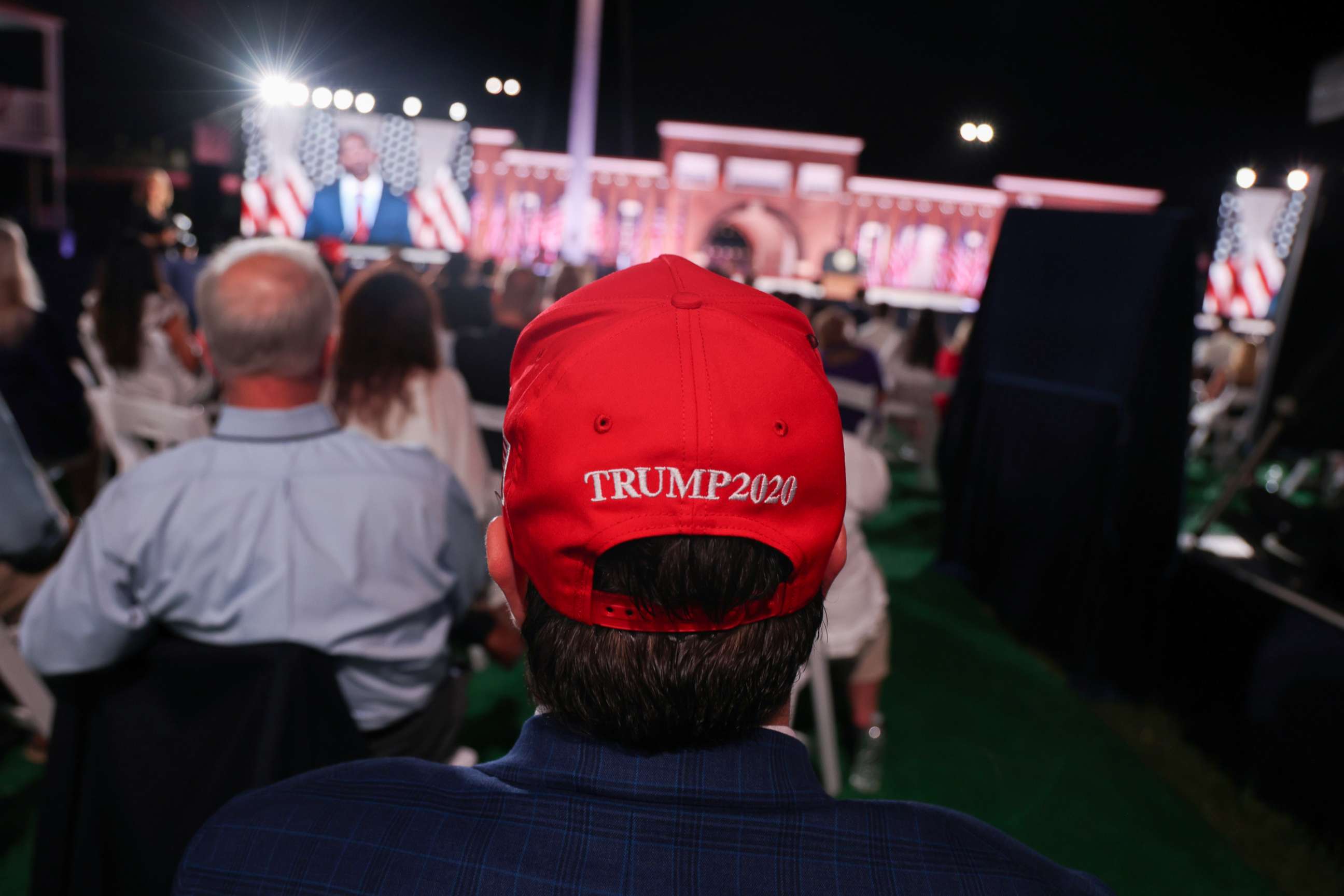 PHOTO: A supporter of President Donald Trump waits for the arrival of  Vice President Mike Pence to deliver his acceptance speech during an event of the 2020 Republican National Convention held at Fort McHenry in Baltimore, Aug. 26, 2020.