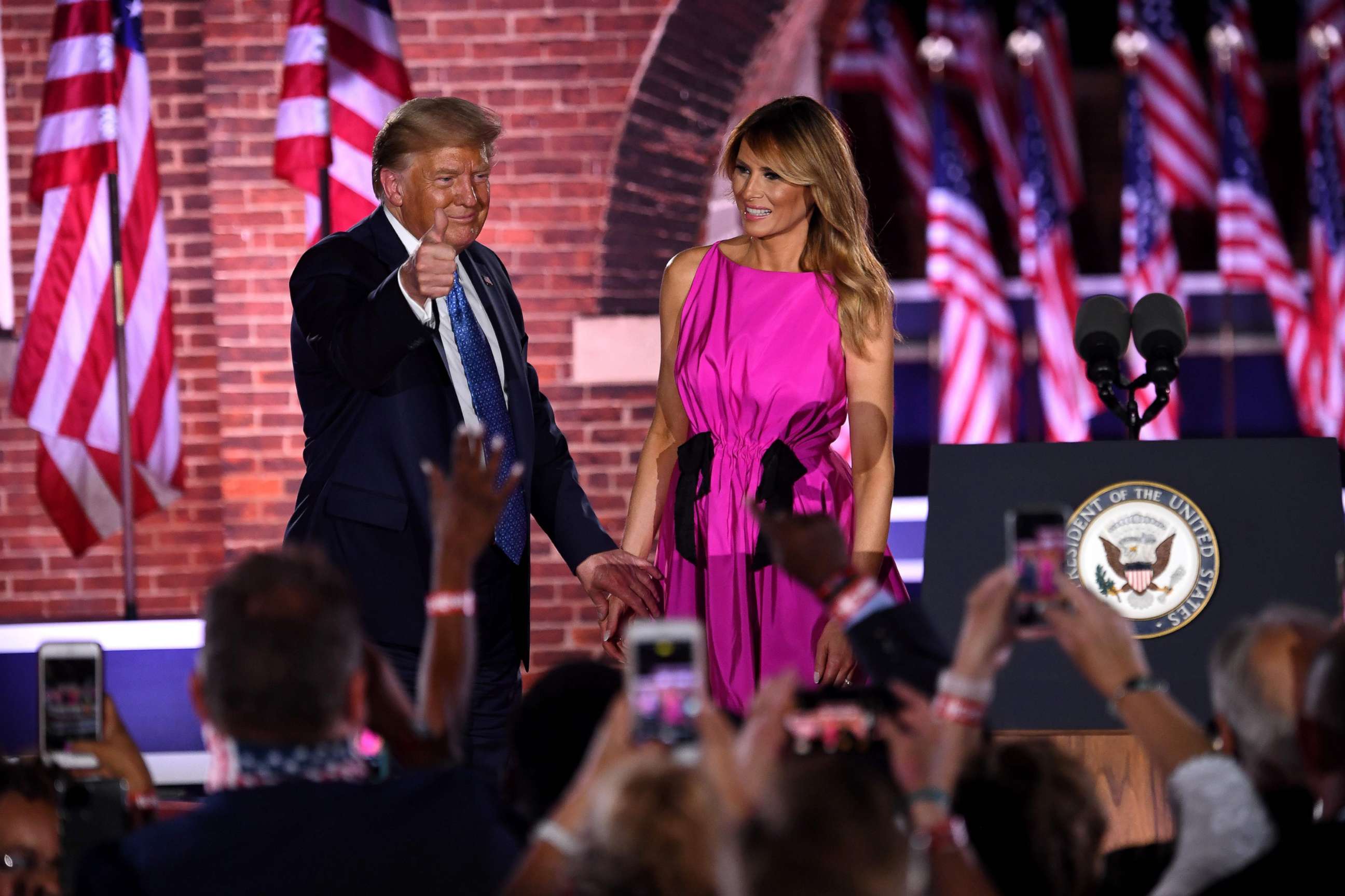PHOTO: First lady Melania Trump and President Donald Trump greet to attendees during the third night of the Republican National Convention at Fort McHenry National Monument in Baltimore, Aug. 26, 2020.