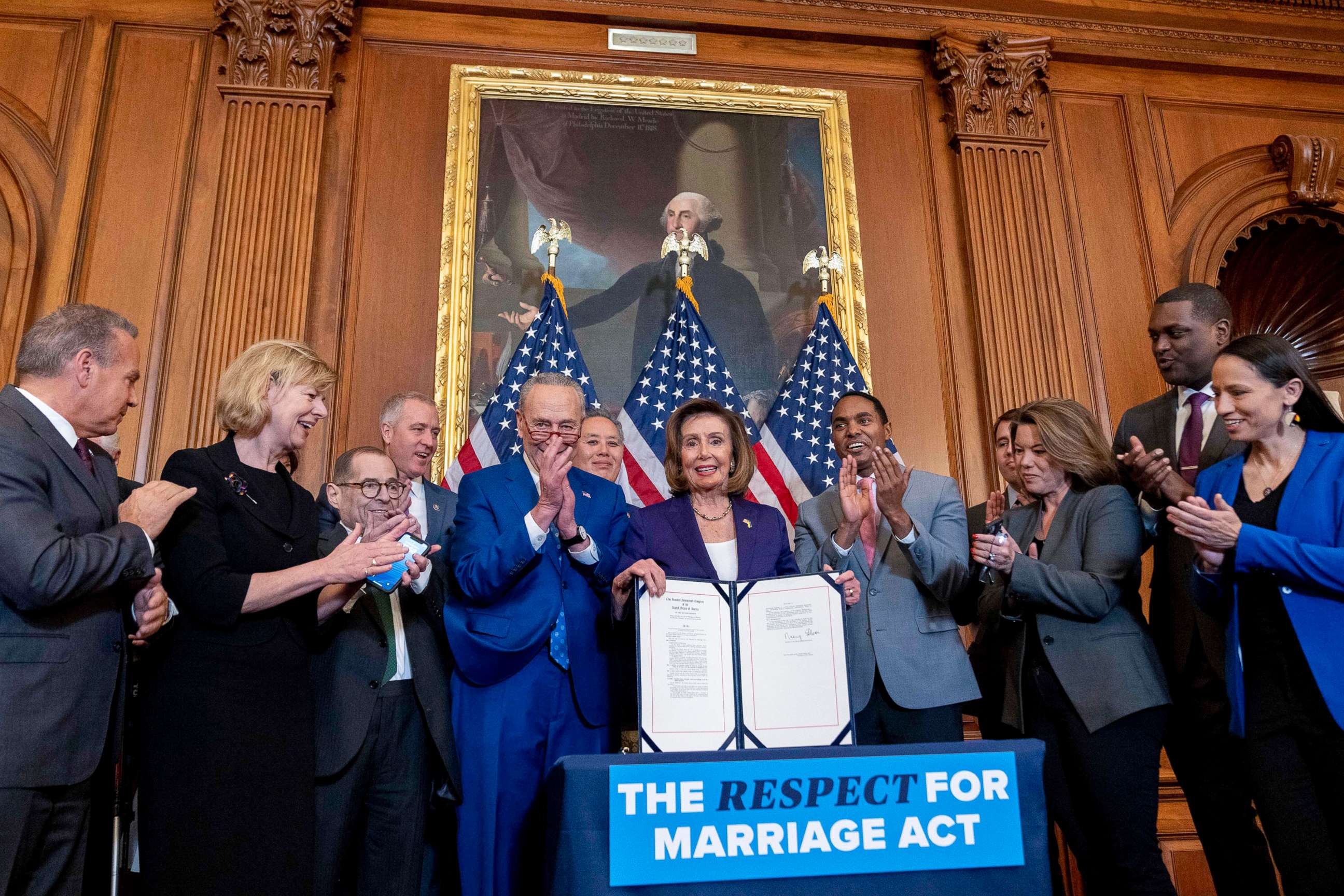 PHOTO: House Speaker Nancy Pelosi, accompanied by Sen. Chuck Schumer, center left, and other members of congress, signs the H.R. 8404, the Respect For Marriage Act, on Capitol Hill in Washington, Dec. 8, 2022.