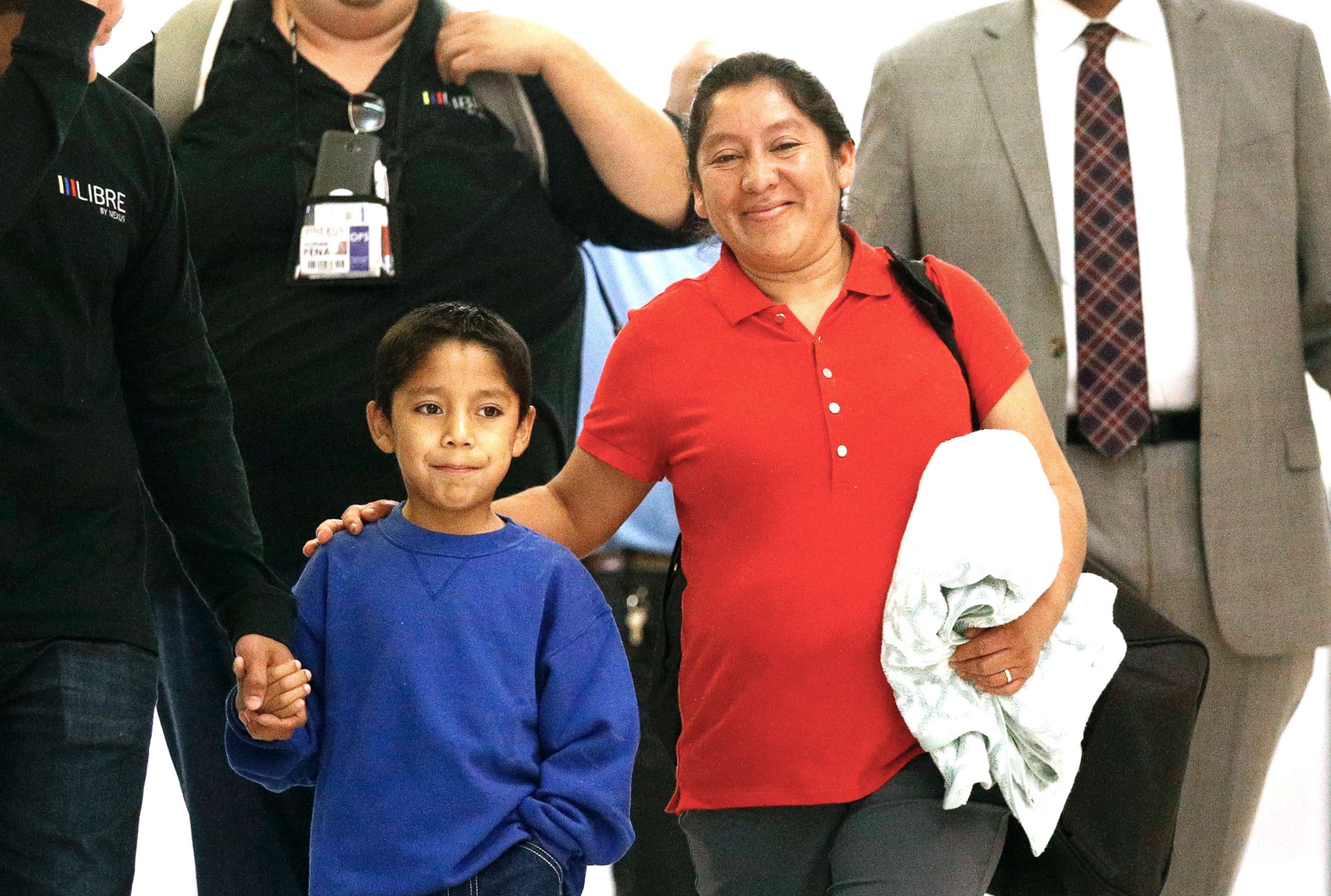 PHOTO: Darwin Micheal Mejia, left, and his mother Beata Mariana de Jesus Mejia-Mejia are escorted to a news conference after their reunion at Baltimore-Washington International Thurgood Marshall Airport on June 22, 2018, in Linthicum, Md.