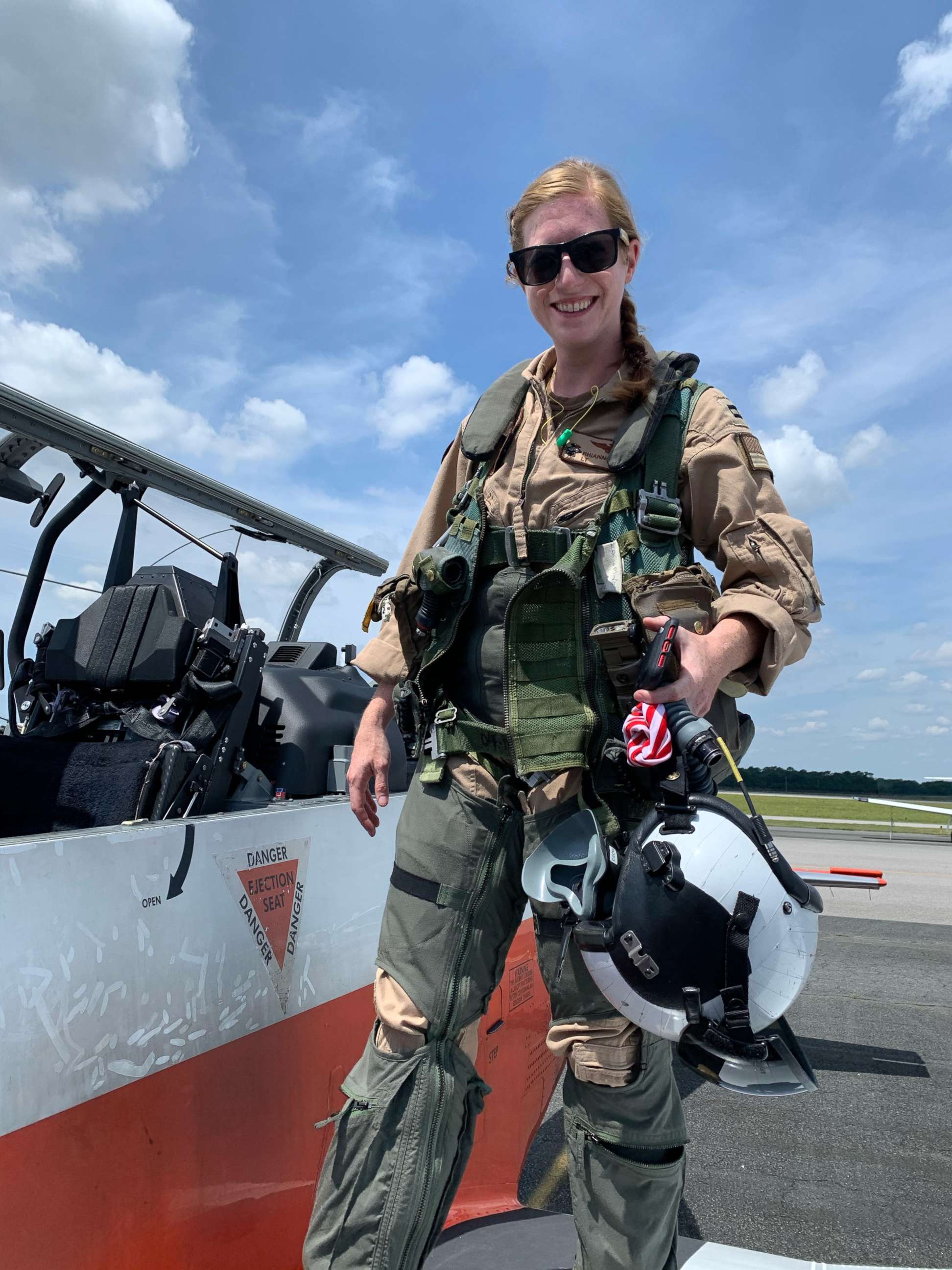 PHOTO: U.S. Navy Lt. Rhiannon Ross, an instructor pilot, stands in front of a T-6B Texan II primary flight trainer aircraft at Naval Air Station Whiting Field in Milton, Fla.