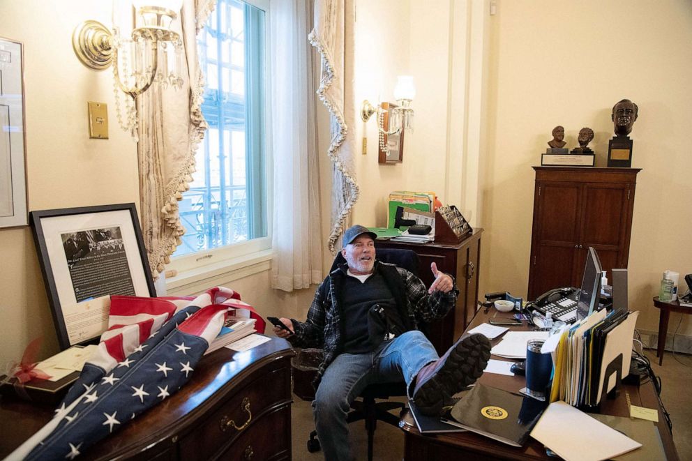 PHOTO: Richard Barnett, a supporter of President Donald Trump sits inside the office of Speaker of the House Nancy Pelosi as he protests inside the US Capitol in Washington, DC, Jan. 6, 2021.