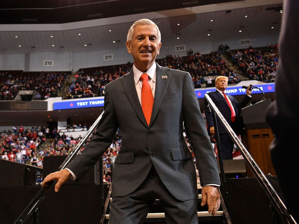 PHOTO: Louisiana Republican Gubernatorial candidate Eddie Rispone leaves the stage as US president Donald Trump watches during a Keep America Great rally in Bossier City, Louisiana on November 14, 2019.