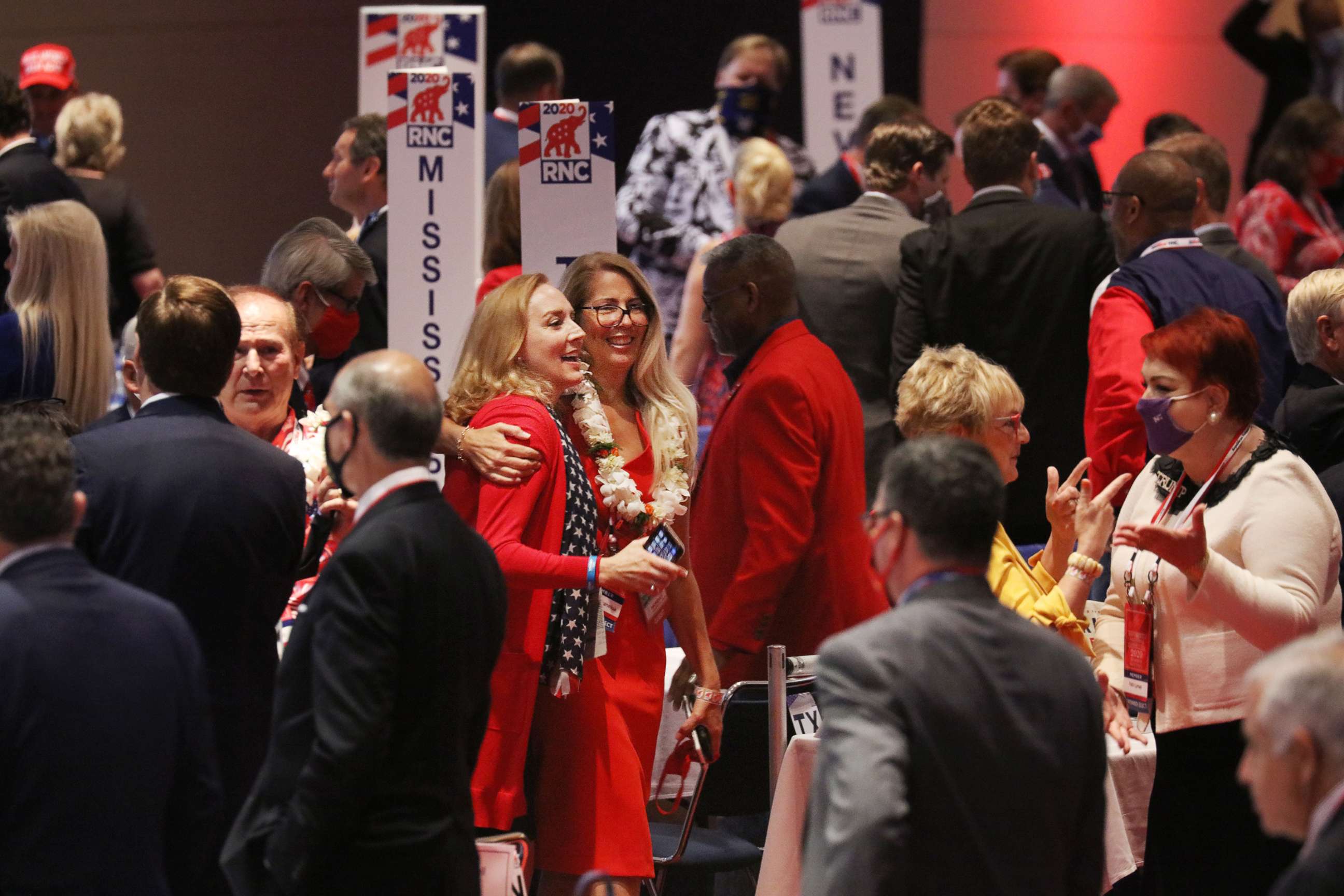 PHOTO: People mingle at the conclusion of President Trump's speech to delegates on the first day of the Republican National Convention at the Charlotte Convention Center on Aug. 24, 2020, in Charlotte, N.C.