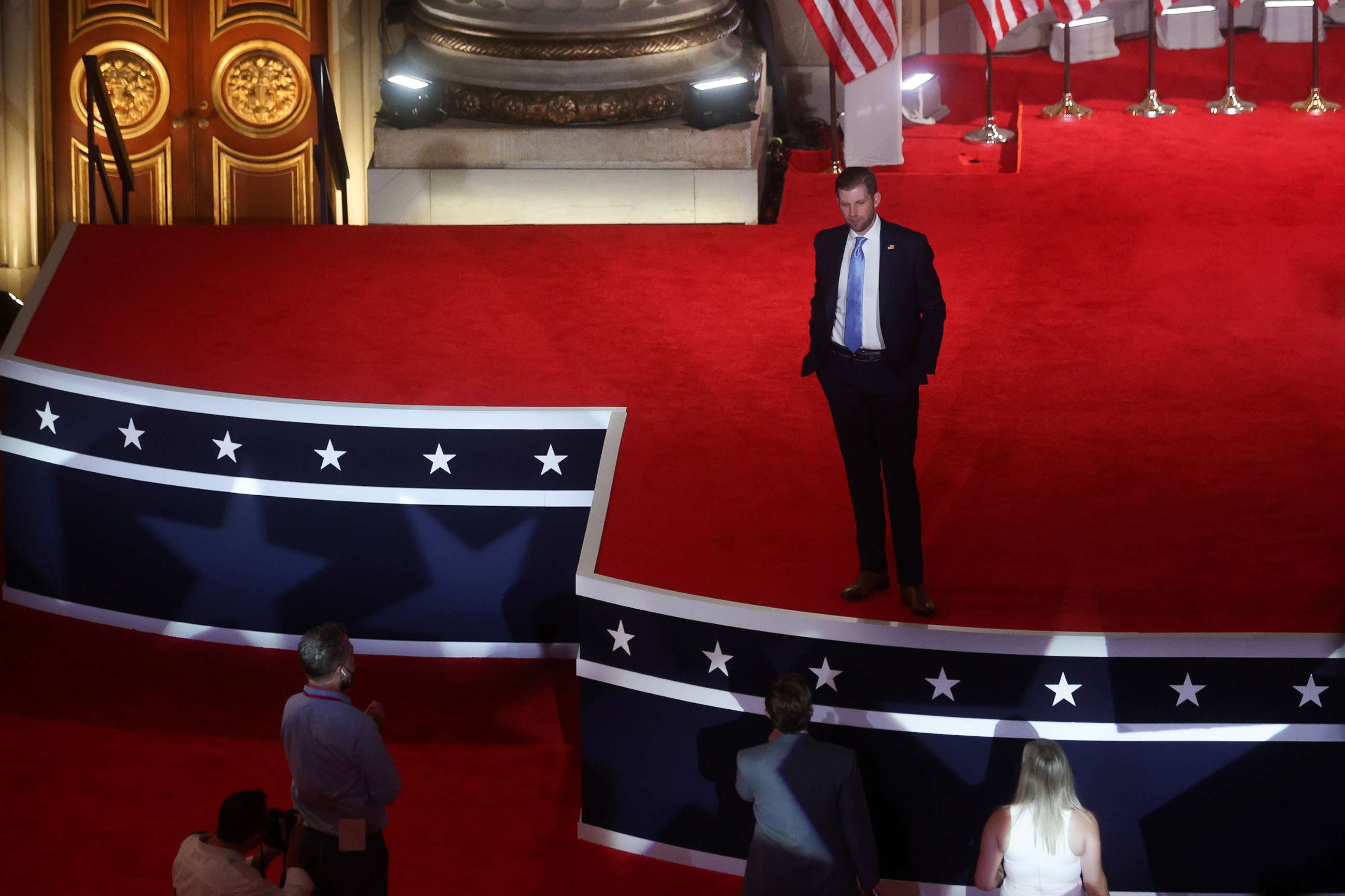 PHOTO: Eric Trump, the son of U.S. President Donald Trump, talks with production staff after delivering a pre-recorded speech for the Republican National Convention broadcast from the nearly-empty Mellon Auditorium in Washington, Aug. 25, 2020.