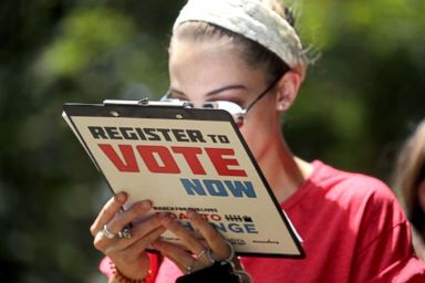 PHOTO: Chloe Weiland registers to vote during the Road to Change bus tour, July 28, 2018, in Tallahassee, Fla.