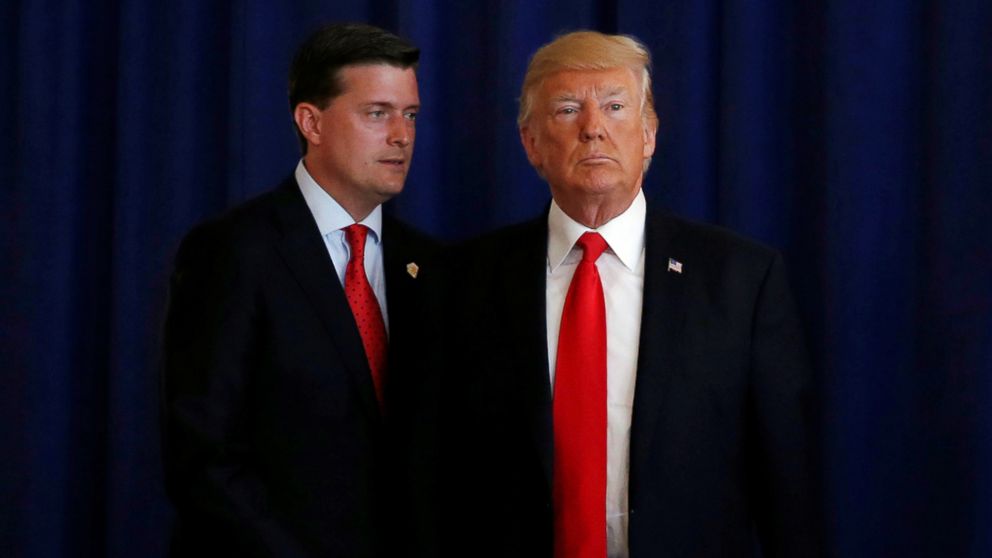 PHOTO: White House Staff Secretary Rob Porter (L) reminds President Donald Trump he had a bill to sign after he departed quickly following remarks at his golf estate in Bedminster, N.J., Aug. 12, 2017.