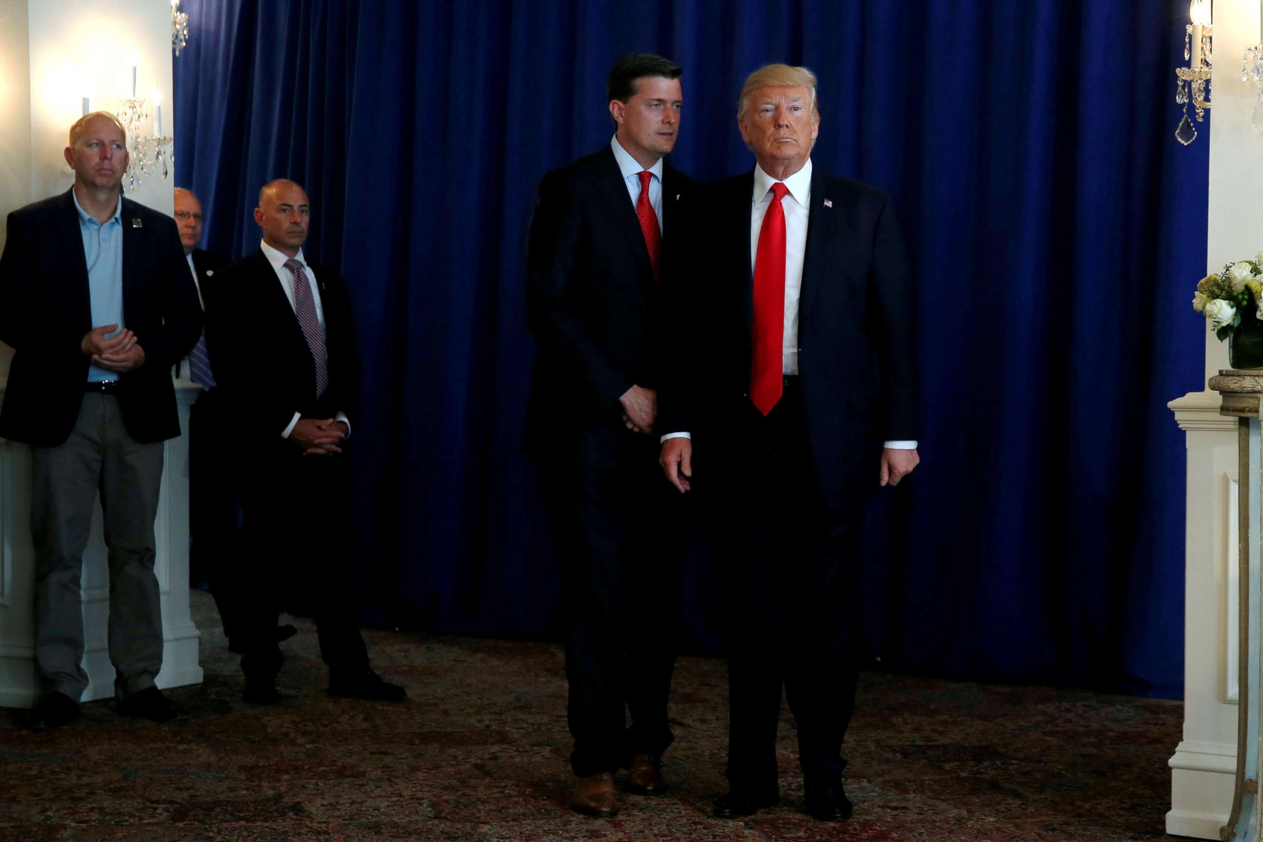 PHOTO: White House Staff Secretary Rob Porter speaks to President Donald Trump at his golf estate in Bedminster, N.J., Aug. 12, 2017.