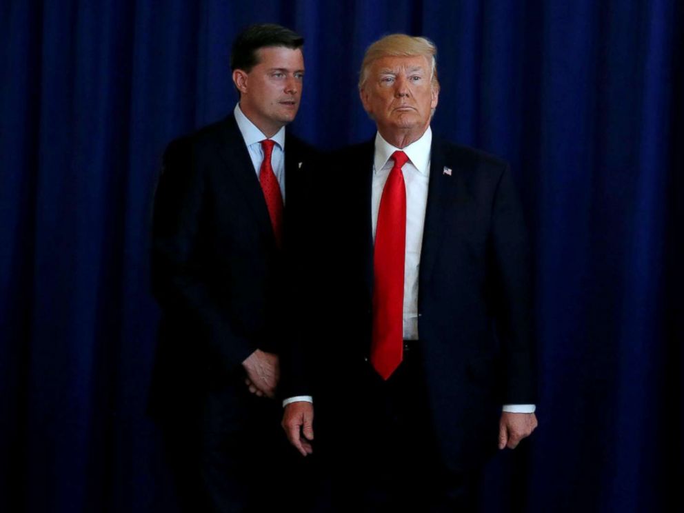 PHOTO: White House Staff Secretary Rob Porter speaks to President Donald Trump at his golf estate in Bedminster, N.J., Aug. 12, 2017.