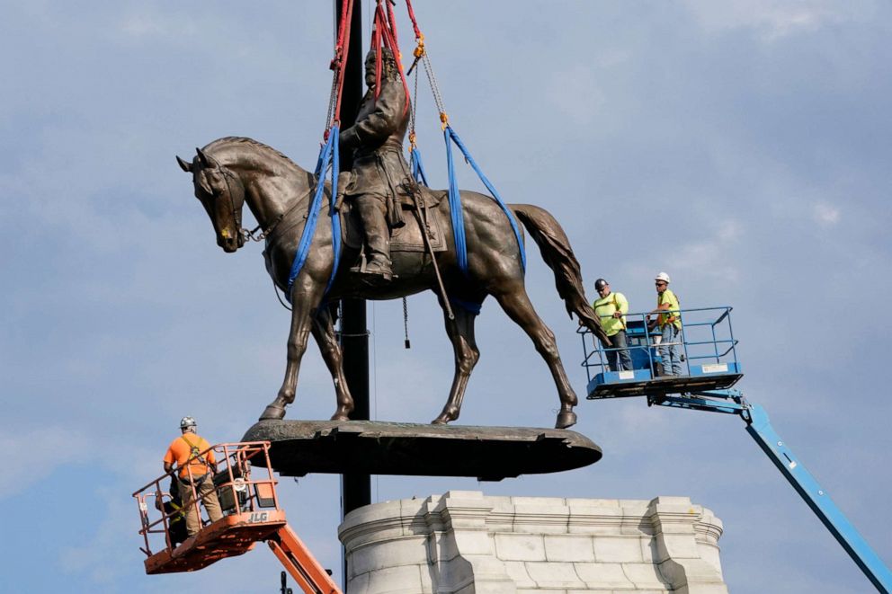 PHOTO: Crews remove one of the country's largest remaining monuments to the Confederacy, a towering statue of Confederate General Robert E. Lee on Monument Avenue in Richmond, Va., Sept. 8, 2021.