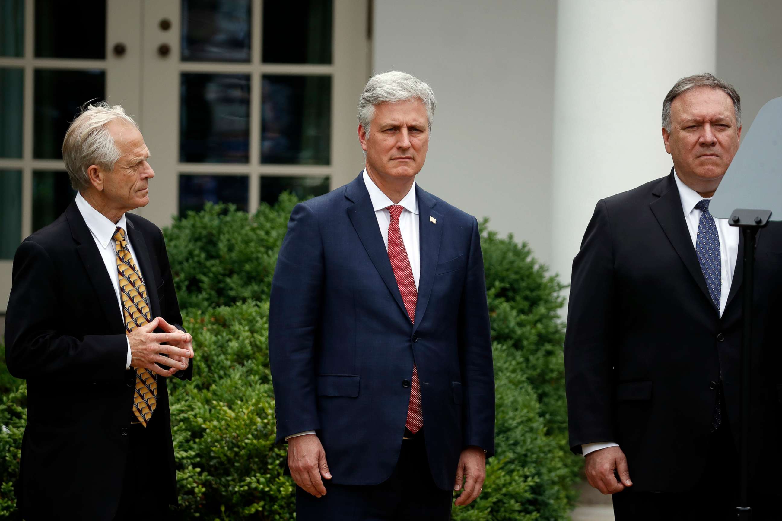 PHOTO: White House trade adviser Peter Navarro, White House national security adviser Robert O'Brien and Secretary of State Mike Pompeo listen as President Donald Trump speaks in the Rose Garden of the White House, May 29, 2020, in Washington.