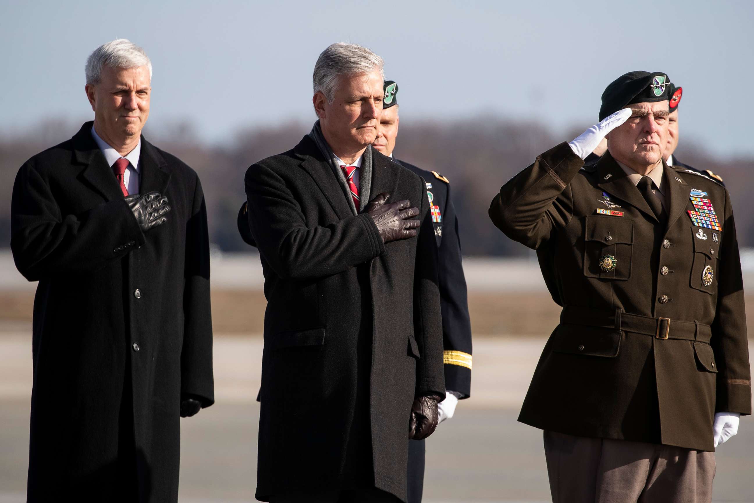 PHOTO: National Security Adviser Robert O'Brien, Joint Chiefs Chairman Gen. Mark Milley, and others stand as a dignified transfer of remains occurs, Dec. 25, 2019, at Dover Air Force Base, Del.