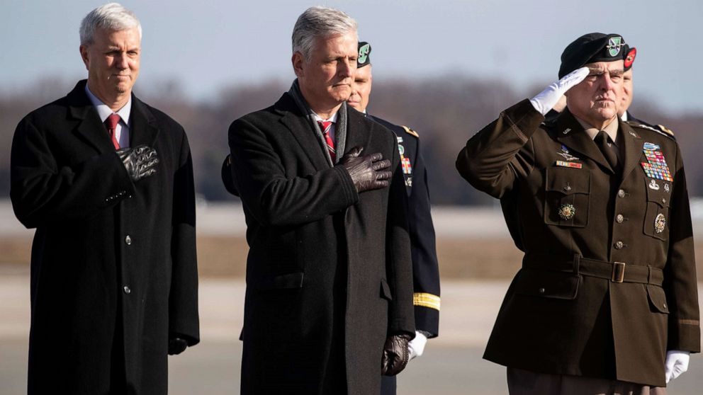 PHOTO: National Security Adviser Robert O'Brien, Joint Chiefs Chairman Gen. Mark Milley, and others stand as a dignified transfer of remains occurs, Dec. 25, 2019, at Dover Air Force Base, Del.