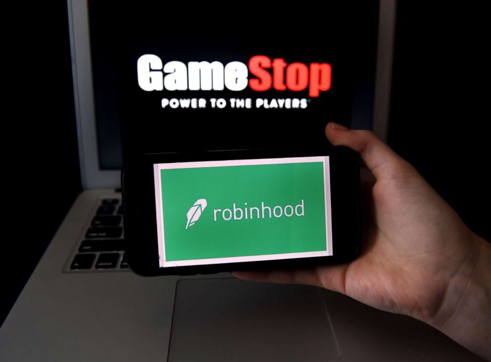 PHOTO: This photo illustration shows the logos of video grame retail store GameStop and trading application Robinhood in a computer and on a mobile phone in Arlington, Va., Jan. 28, 2021. 