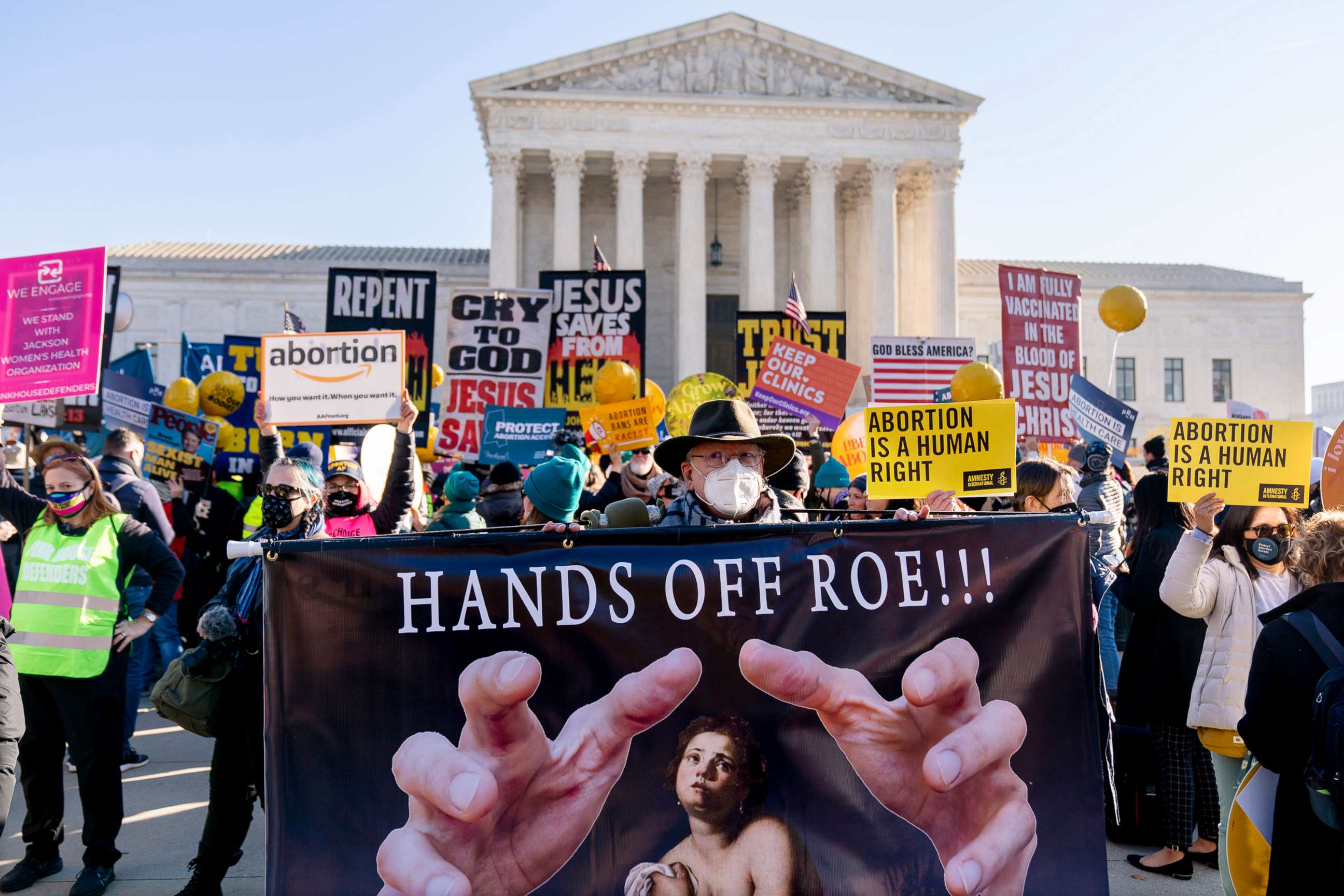 PHOTO: In this Dec. 1, 2021, file photo, Stephen Parlato of Boulder, Colo., holds a sign that reads "Hands Off Roe!!!" as abortion rights advocates and anti-abortion protesters demonstrate in front of the Supreme Court in Washington, D.C.