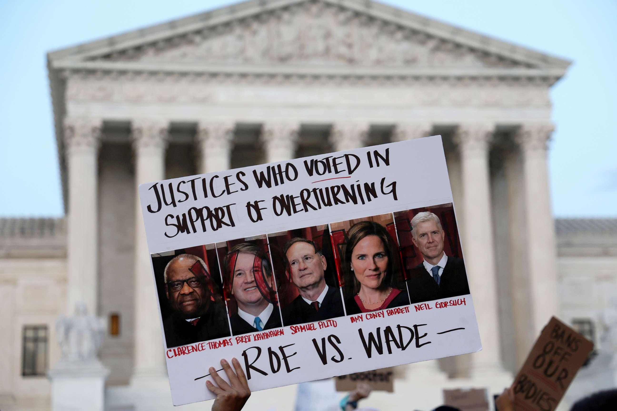 PHOTO: A pro-choice activist holds up a sign during a rally in front of the Supreme Court in response to the leaked Supreme Court draft decision to overturn Roe v. Wade, May 3, 2022 in Washington, DC.