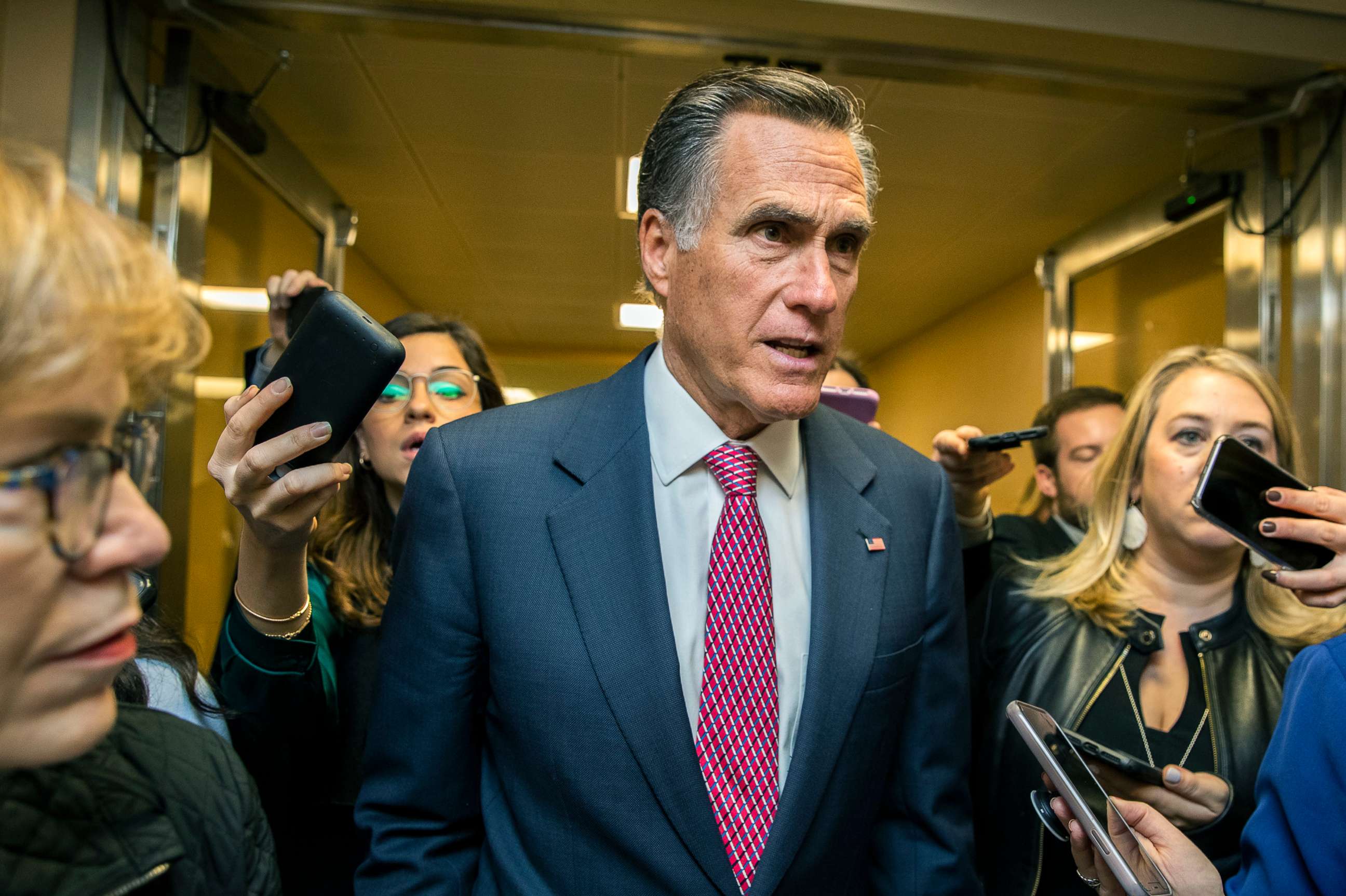 PHOTO: Sen. Mitt Romney speaks to reporters as he arrives at the Capitol, Jan. 27, 2020, during the impeachment trial of President Donald Trump.