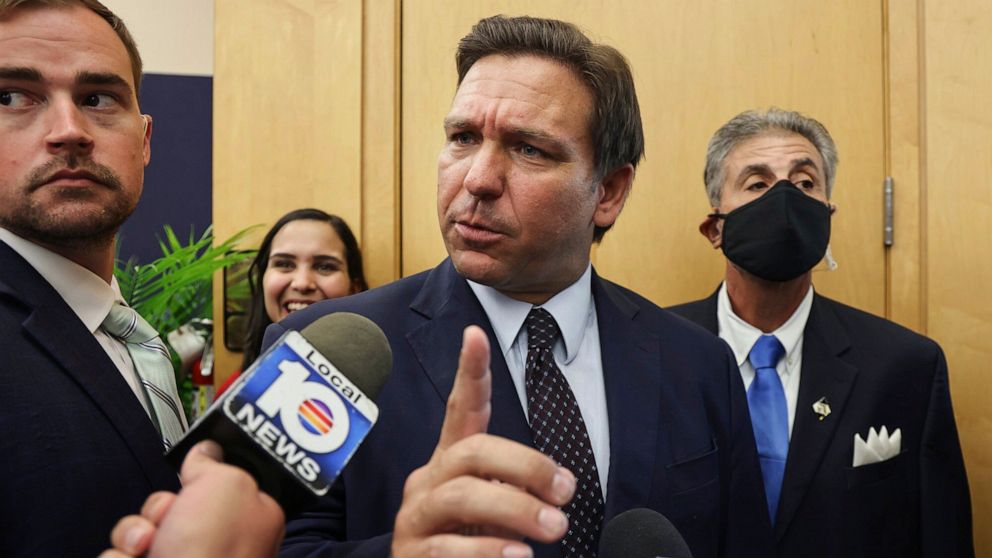 PHOTO: Florida Gov. Ron DeSantis responds to local TV reporter's question after he signed legislation seeking to punish social media platforms that remove conservative ideas from their sites, in Miami on May 24, 2021.