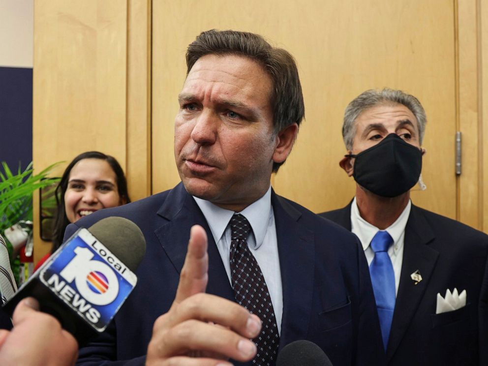 PHOTO: Florida Gov. Ron DeSantis responds to local TV reporter's question after he signed legislation seeking to punish social media platforms that remove conservative ideas from their sites, in Miami on May 24, 2021.