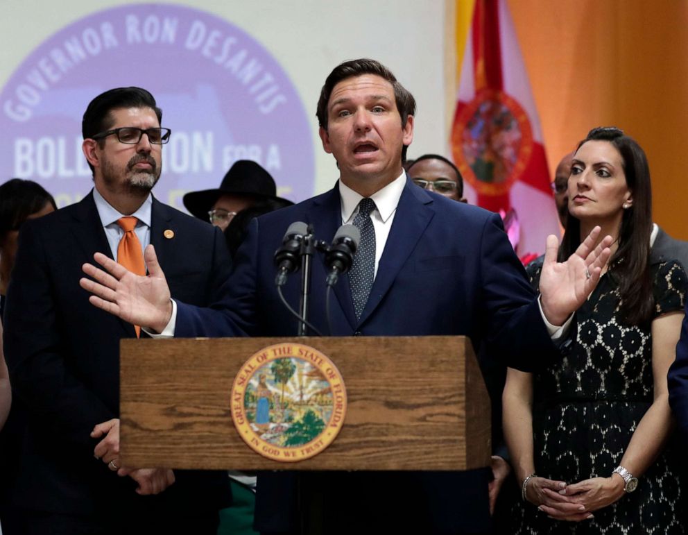 PHOTO: Florida Gov. Ron DeSantis, center, speaks during a bill signing ceremony at the William J. Kirlew Junior Academy in Miami Gardens, Fla., May 9, 2019.