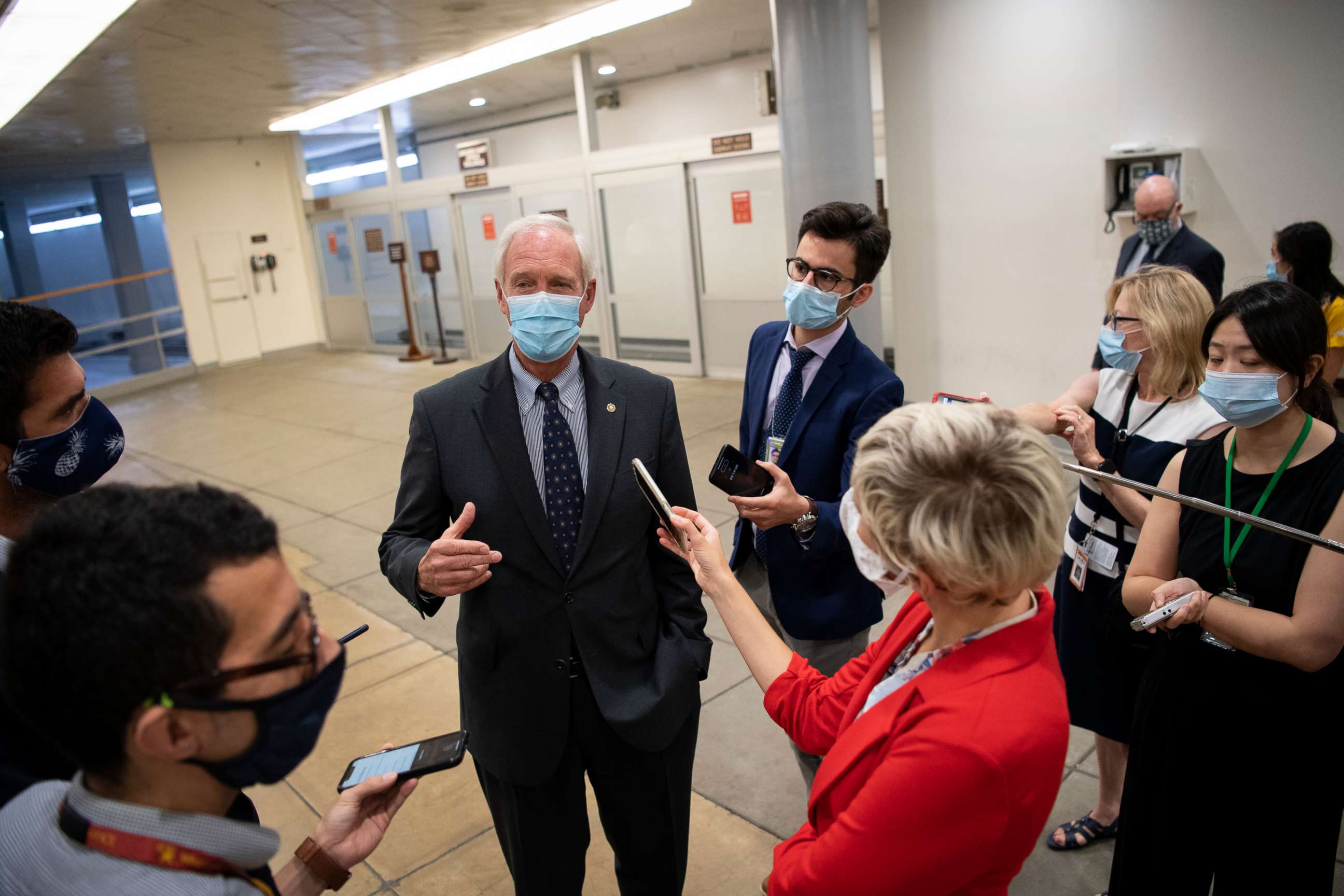 PHOTO: Sen. Ron Johnson talks to members of the press in the Senate Subway on his way to a vote in the Capitol on July 22, 2020, in Washington.