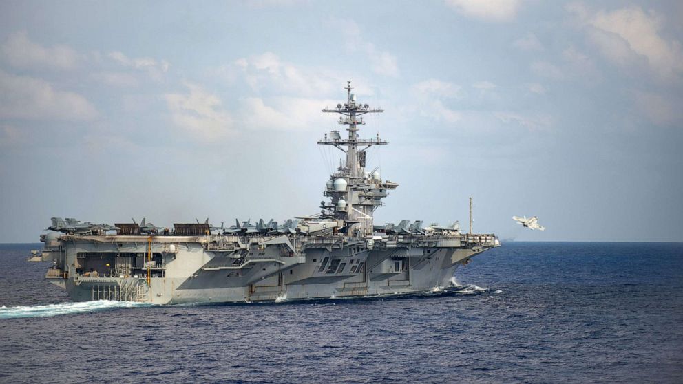 PHOTO: An F/A-18F Super Hornet launches from the flight deck of the aircraft carrier USS Theodore Roosevelt (CVN 71) March 18, 2020.