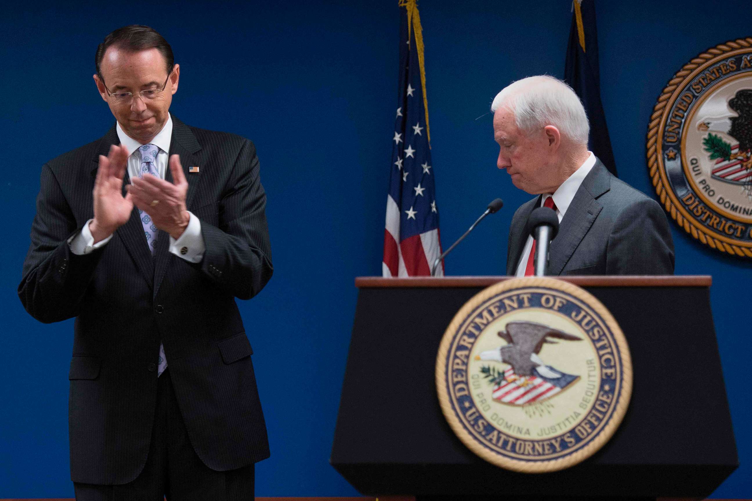 PHOTO: Deputy Attorney General Rod Rosenstein applauds after Attorney General Jeff Sessions, right, made an announcement on efforts to reduce transitional crime during a press conference at the U.S. Attorney's Office in Washington, Oct, 15, 2018.