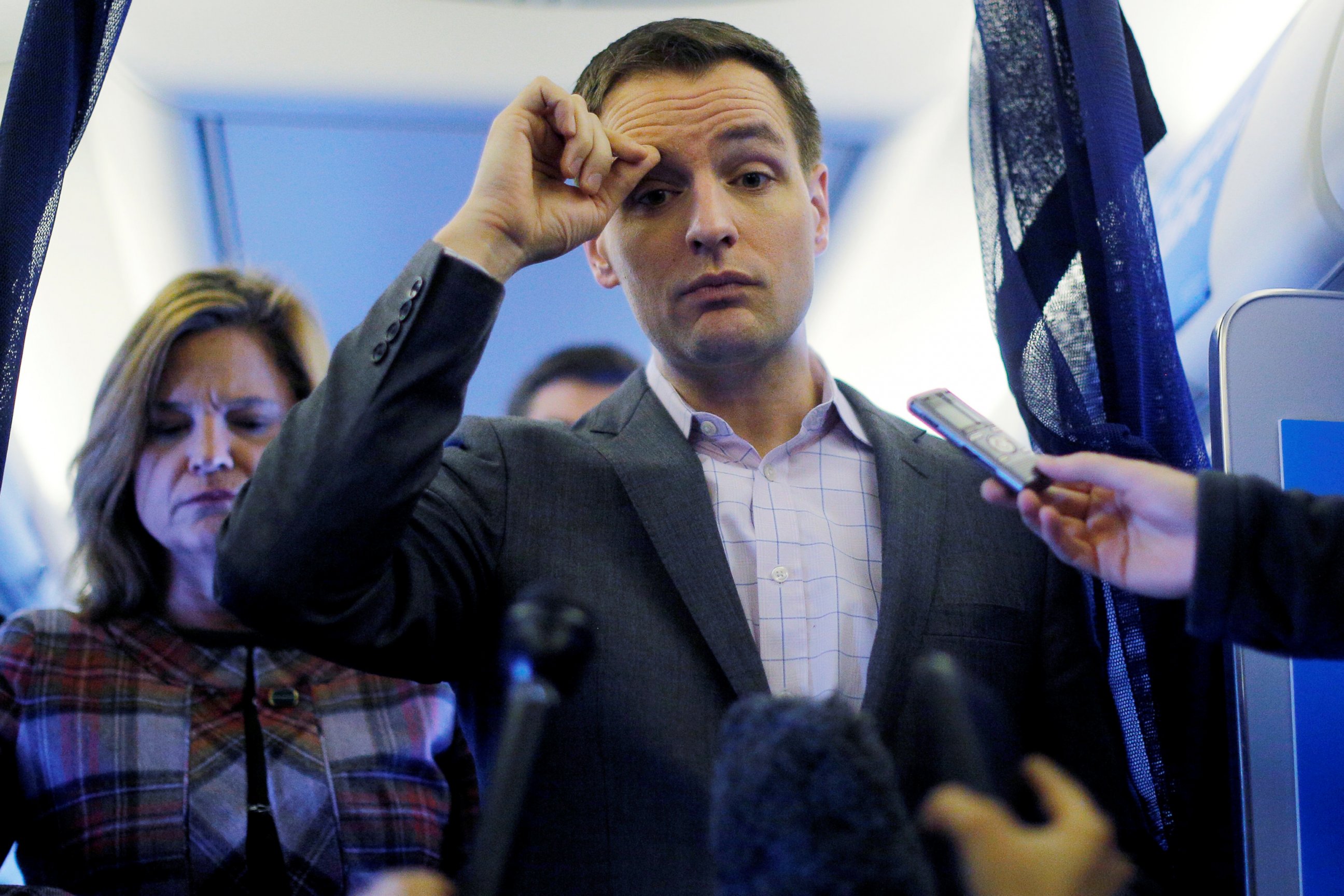 PHOTO: Robby Mook, Campaign Manager for Hillary Clinton, and Communications Director Jen Palmieri, left, talk to reporters onboard the campaign plane enroute to Cedar Rapids, Iowa, Oct. 28, 2016.  