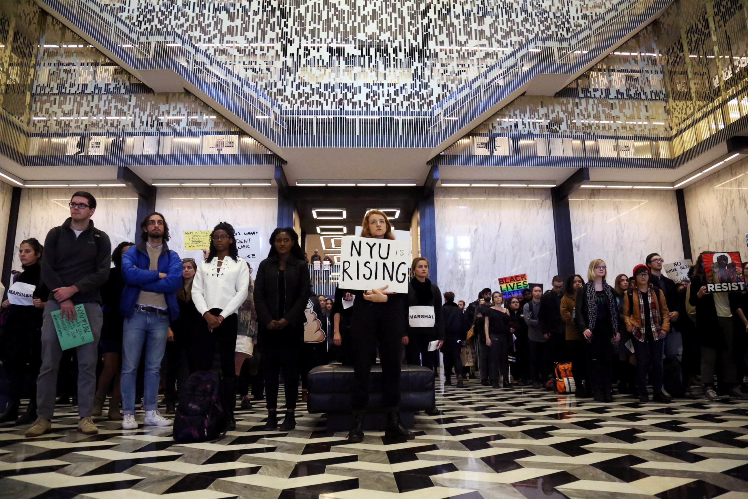 PHOTO: Students of New York University (NYU) stand silent in Elmer Holmes Bobst Library during a demonstration  joining with other colleges across the nation in protest against President-elect Donald Trump in New York, Nov. 16, 2016.