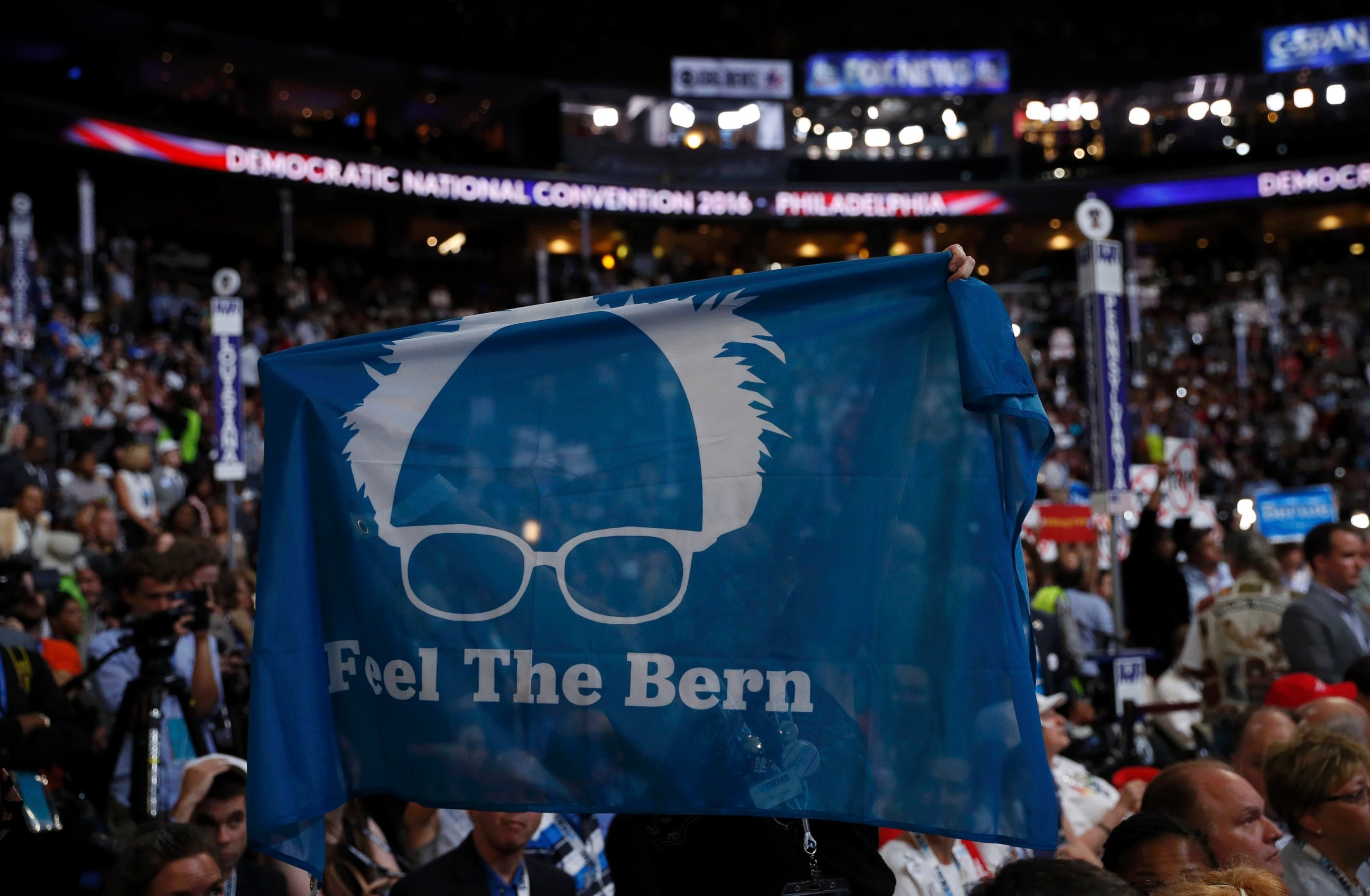 PHOTO: Supporters of Senator Bernie Sanders hold up a "Feel the Bern" banner as they protest on the floor during the first day of the Democratic National Convention in Philadelphia, July 25, 2016.