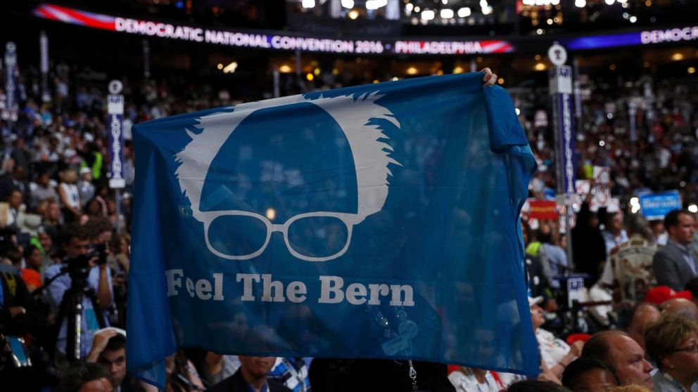 PHOTO: Supporters of Senator Bernie Sanders hold up a "Feel the Bern" banner as they protest on the floor during the first day of the Democratic National Convention in Philadelphia, July 25, 2016.