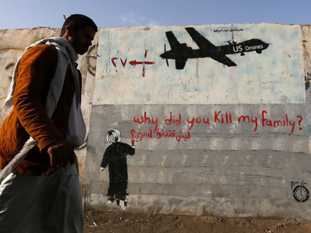 PHOTO: A man walks past a graffiti denouncing strikes by U.S. drones in Yemen on a wall in Sanaa, Nov. 13, 2014.