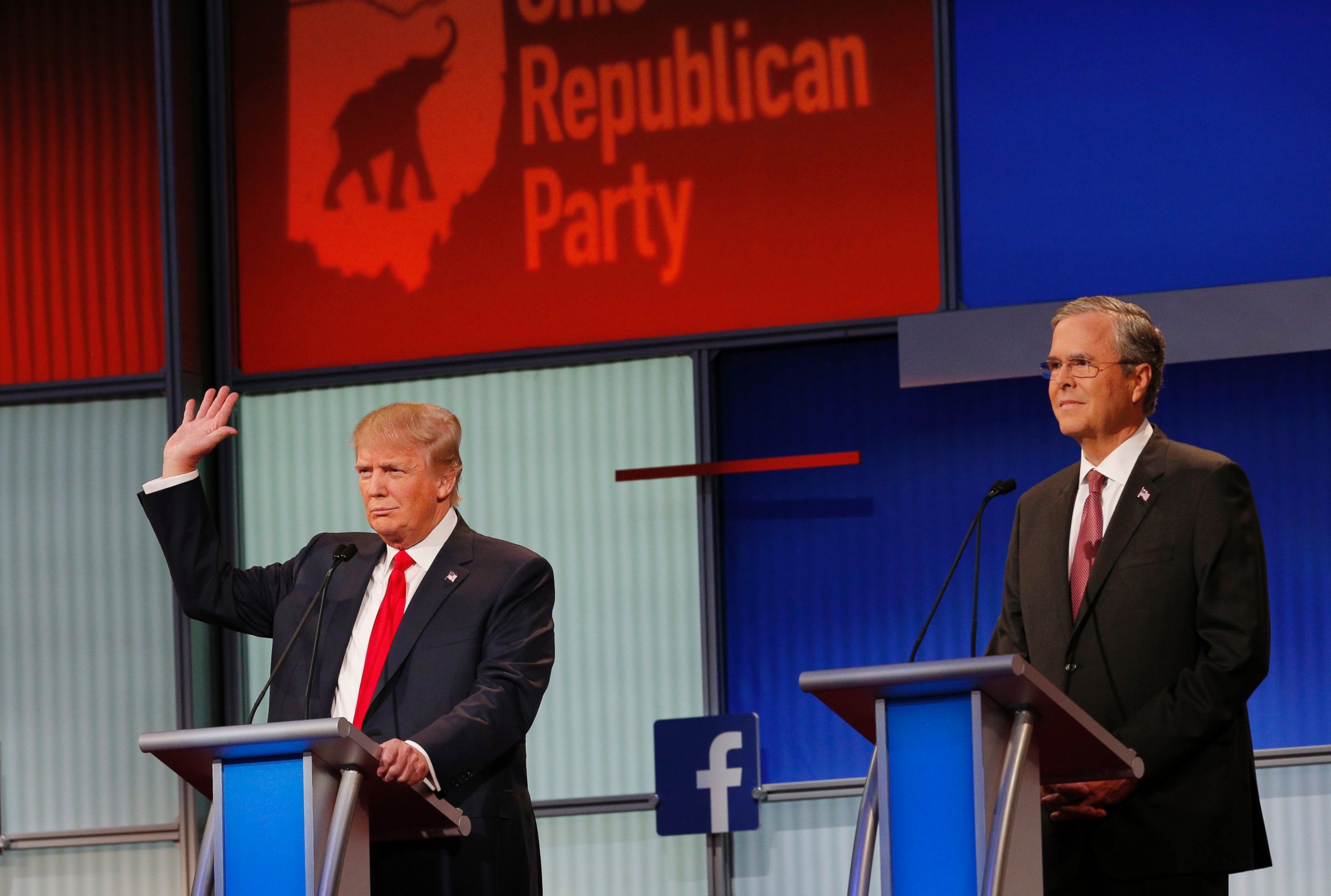 PHOTO: Donald Trump raises his hand to say that he will not take a pledge not to run as an Independent candidate for president as former Governor Jeb Bush looks on at the first Republican presidential candidates debate in Ohio, Aug. 6, 2015.