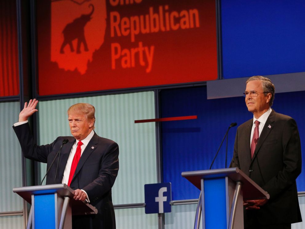 PHOTO: Donald Trump raises his hand to say that he will not take a pledge not to run as an Independent candidate for president as former Governor Jeb Bush looks on at the first Republican presidential candidates debate in Ohio, Aug. 6, 2015.
