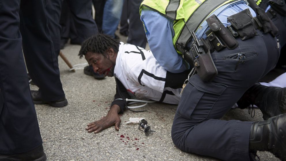Police detain a man after a fight between supporters and opponents of U.S. Republican presidential candidate Donald Trump, ahead of his speech outside the Peabody Opera House in St. Louis, Missouri, March 11, 2016.