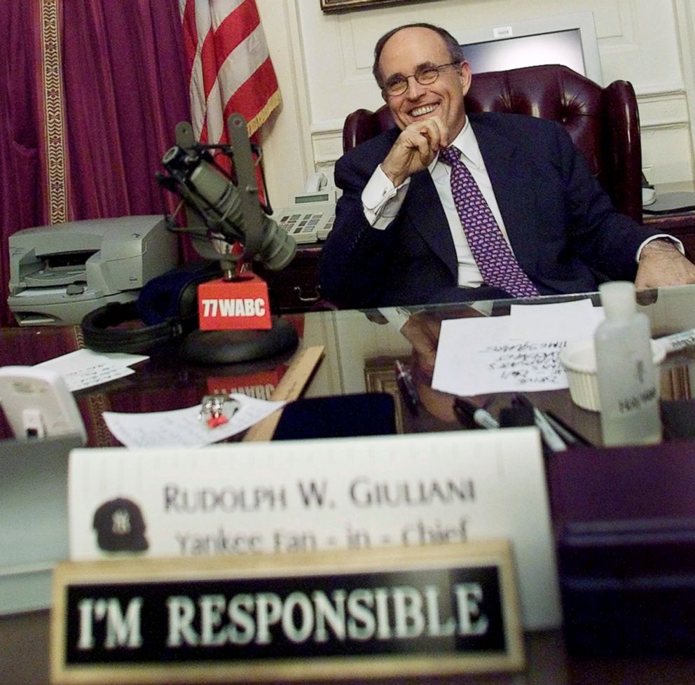 PHOTO: New York City Mayor Rudolph Giuliani smiles as he takes a break during his final live radio show, Dec. 28, 2001, at his City Hall office in New York.