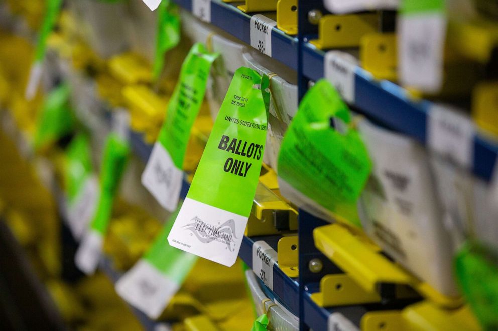 PHOTO: "Official Election Mail" tags are displayed on bins of ballots at the Runbeck Election Services facility in Phoenix, June 23, 2020. 