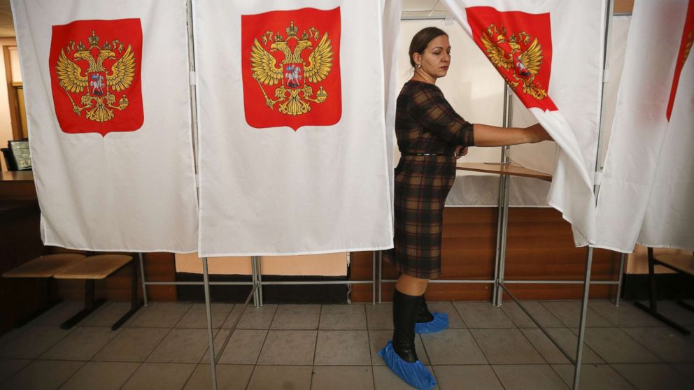 PHOTO: A member of a local electoral commission walks out of a voting booth at a polling station during preparations for the upcoming presidential election in Moscow, March 16, 2018.