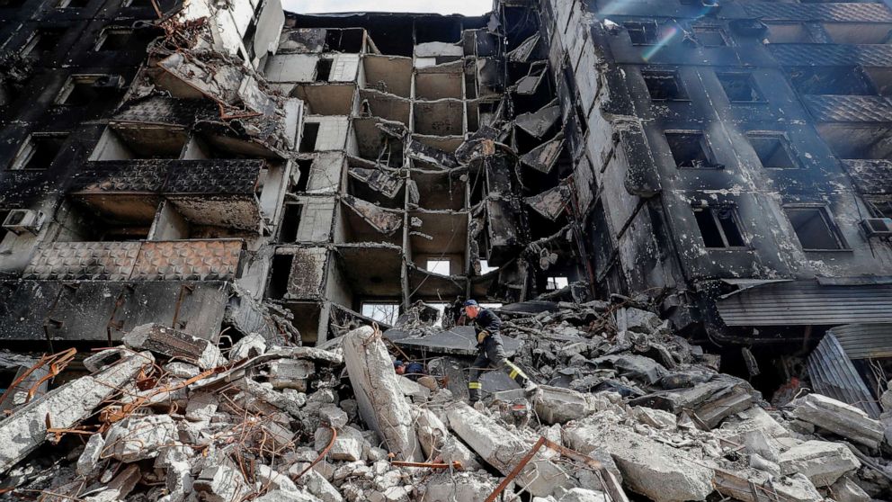 PHOTO: Emergency workers remove debris of a building destroyed in the course of the Ukraine-Russia conflict, in the southern port city of Mariupol, Ukraine April 10, 2022.