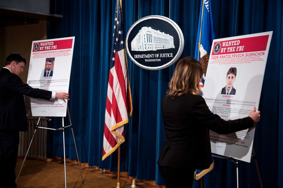PHOTO: Staff members reveal wanted posters for two of three Russians charged with the 2014 hack of Yahoo before a press conference at the U.S. Department of Justice on March 15, 2017, in Washington.