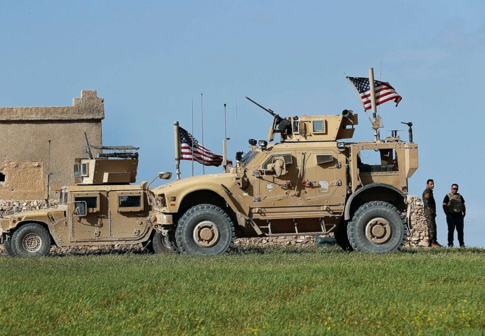 PHOTO: Soldiers of the U.S-backed Syrian Manbij Military Council, a part of the SDF, stand next to a U.S. humvee at a U.S. military outpost on a road leading to the front lines between Syria and Turkish backed fighter,north of Manbij, Syria. 