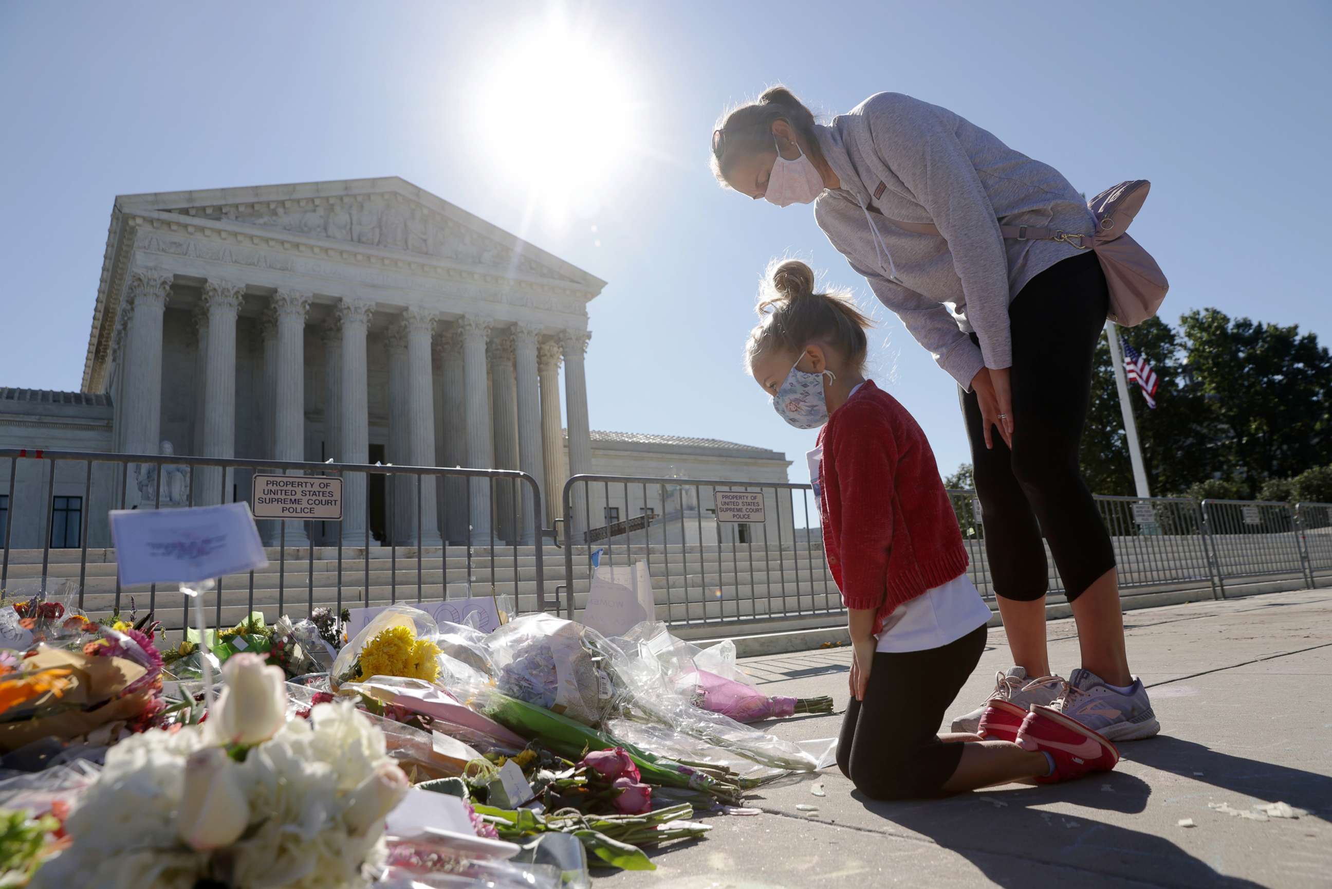 PHOTO: Abby Martin of Arlington, Va., pays respect with her mother Jackie Martin as they visit a makeshift memorial in front of the U.S. Supreme Court for the late Justice Ruth Bader Ginsburg in Washington,  Sept. 21, 2020.