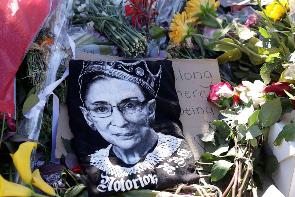 PHOTO: Signs and flowers are left at a makeshift memorial in front of the U.S. Supreme Court for the late Justice Ruth Bader Ginsburg Sept. 21, 2020.