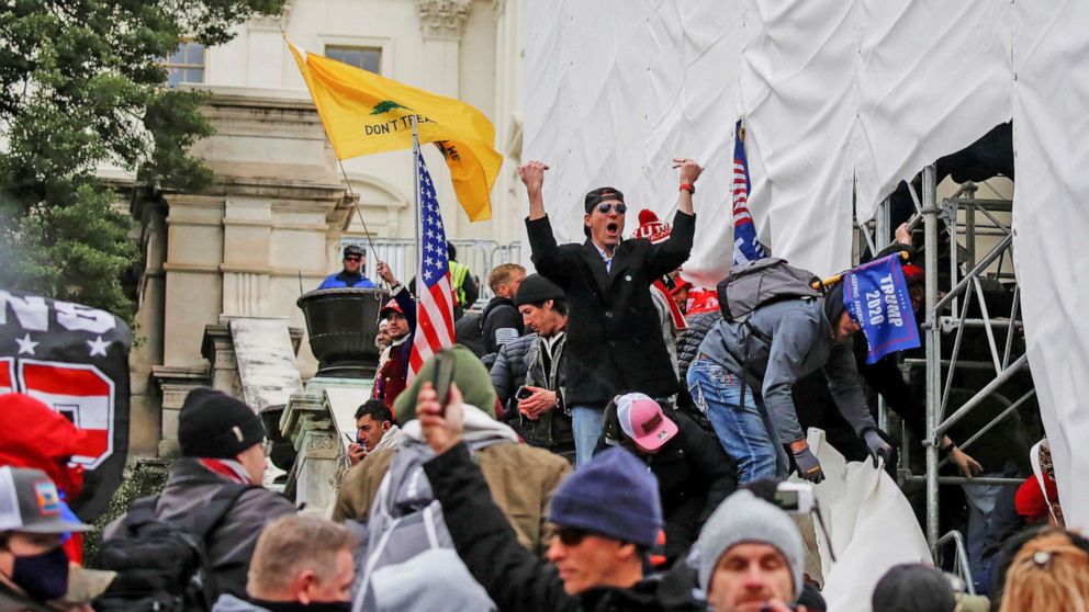 PHOTO: Supporters of President Donald Trump, including a person identified as Ryan Kelley, center, make their way past barriers at the U.S. Capitol during a protest against the certification of the 2020 presidential election results, in Washington, D.C.