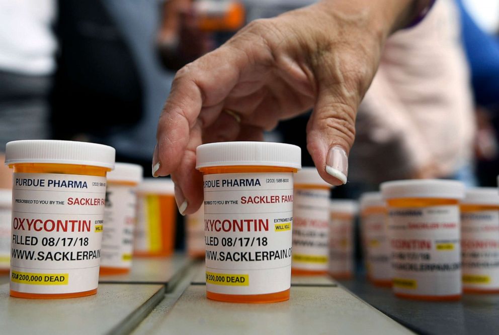 PHOTO: Family and friends who have lost loved ones to OxyContin and opioid overdoses leave pill bottles in protest outside the headquarters of Purdue Pharma, which is owned by the Sackler family, in Stamford, Conn., Aug. 17, 2018.