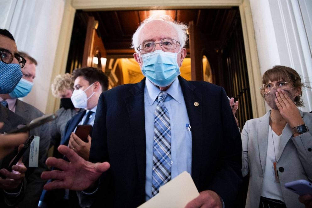 PHOTO: Sen. Bernie Sanders talks with reporters while leaving the U.S. Capitol on Monday, Aug. 9, 2021.