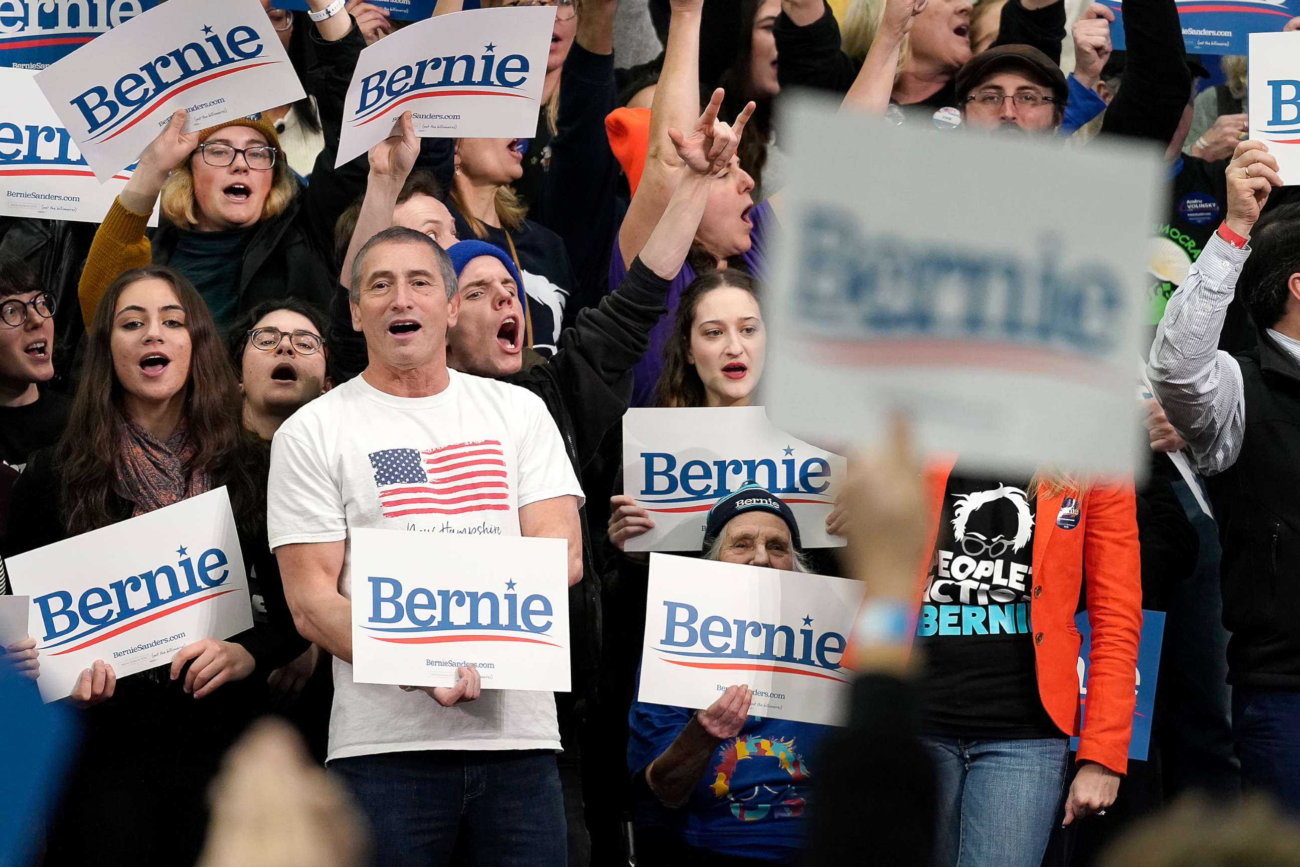 PHOTO: Supporters of Democratic presidential candidate Bernie Sanders watch results come in at Sanders' New Hampshire primary night event, Feb. 11, 2020, in Manchester, N.H. 