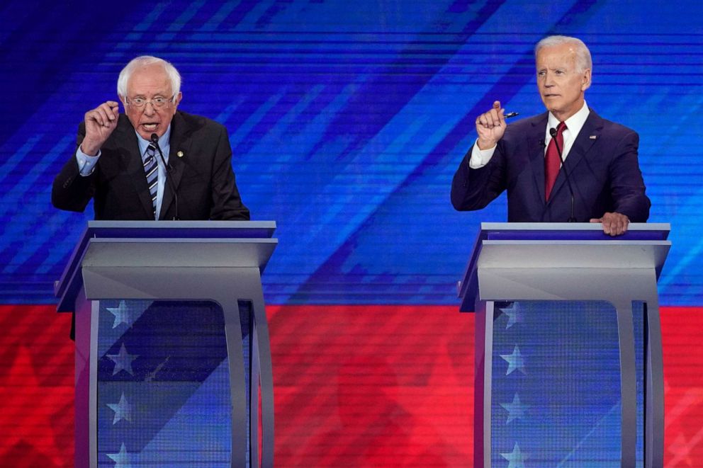 PHOTO: Sen. Bernie Sanders, left, and former Vice President Joe Biden, right, talk during a Democratic presidential primary debate hosted by ABC at Texas Southern University in Houston.