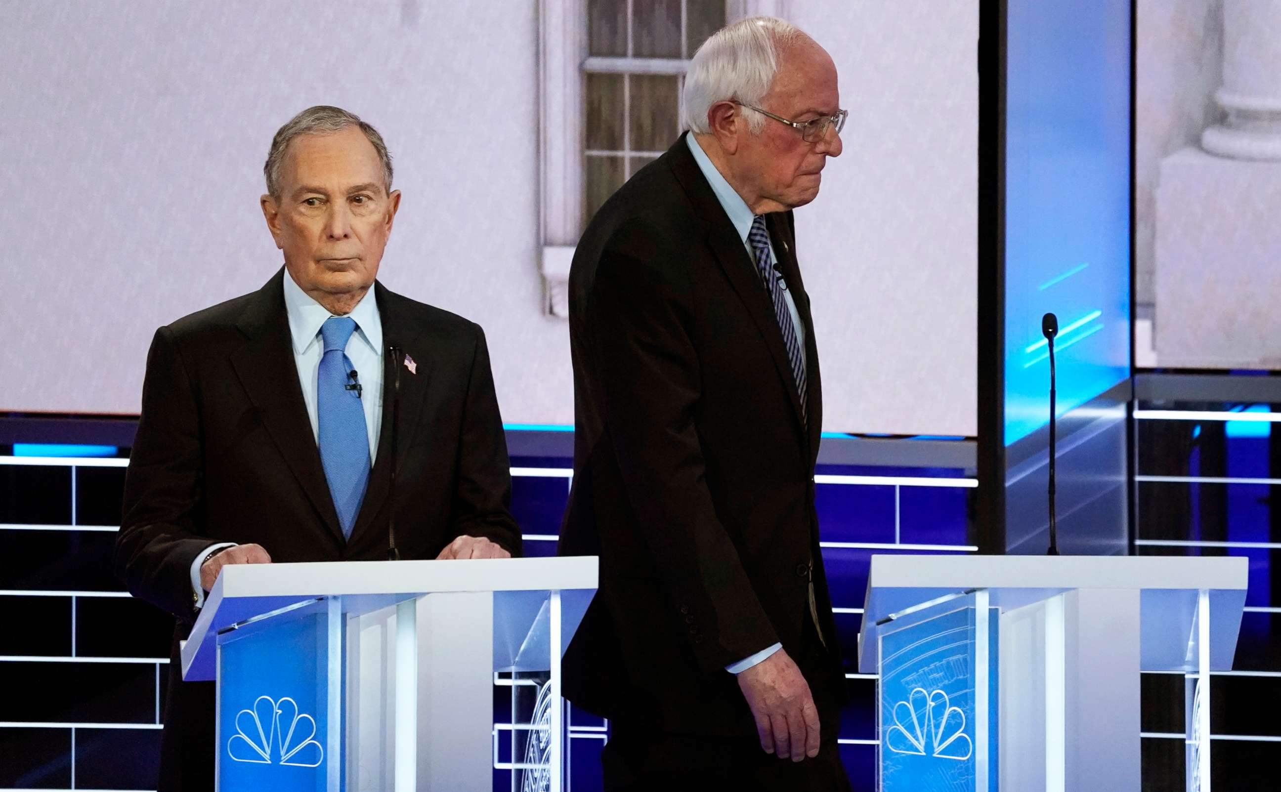 PHOTO: Sen. Bernie Sanders walks behind former New York City Mayor Mike Bloomberg during a break at the ninth Democratic 2020 Presidential candidates debate at the Paris Theater in Las Vegas, Feb. 19, 2020.