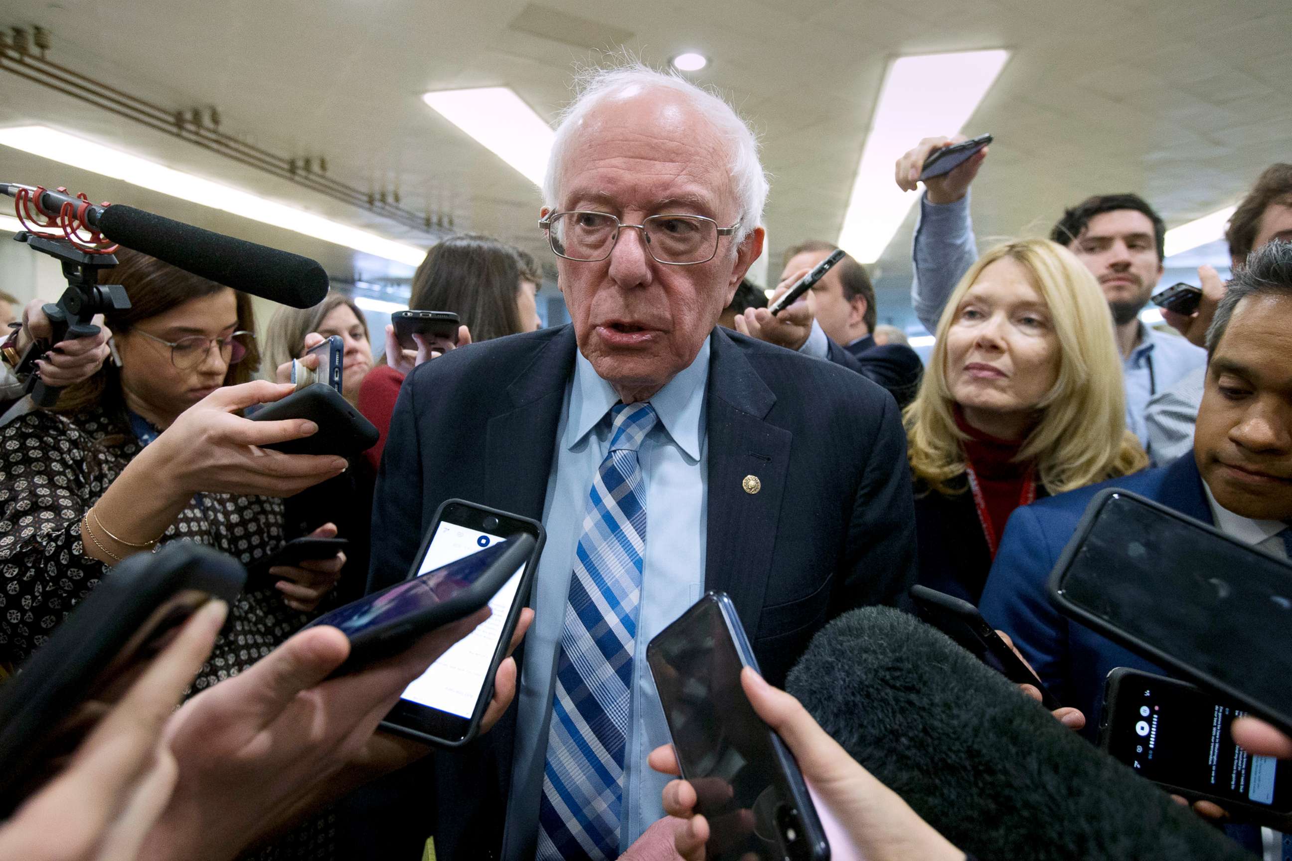 PHOTO: Sen. Bernie Sanders talks to reporters as he arrives at the Senate for the start of the impeachment trial of President Donald Trump, Jan. 21, 2020, at the Capitol in Washington, D.C.